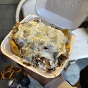  a person holding a container of food