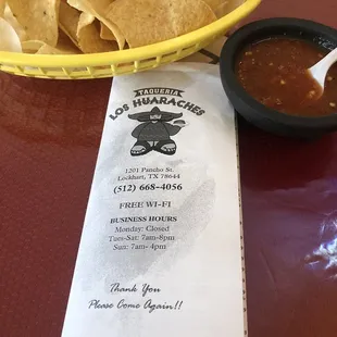 a plate of tortillas and a bowl of salsa