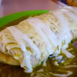 The Queso steak burrito covered in homemade verde salsa, cheese &amp; crema. So good!!!