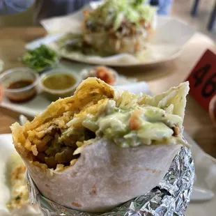 Polla asado super burrito. Carnitas taco salad in the background.