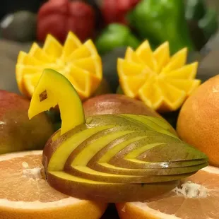 a bird carved out of fruit
