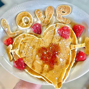 a plate of pancakes and strawberries