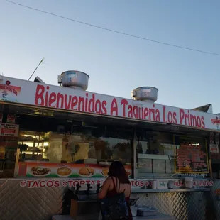 a woman standing in front of a food truck