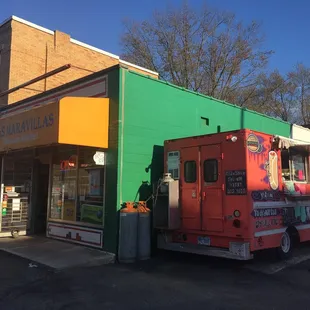 The taco truck is in the parking lot of the Las Maravillas market...