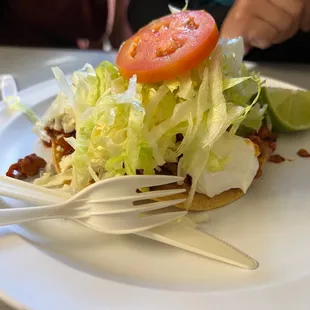 a taco with lettuce and tomatoes
