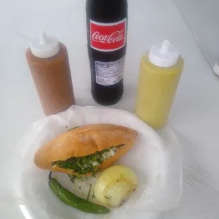 a plate of food and a bottle of coke