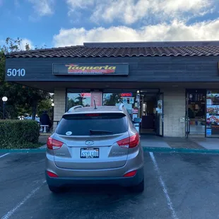 a car parked in front of a taqueria