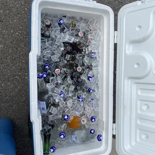 a cooler full of beer bottles