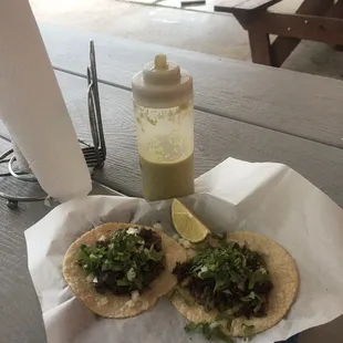 two tacos on a picnic table