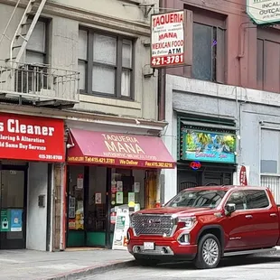 a red truck parked in front of a store