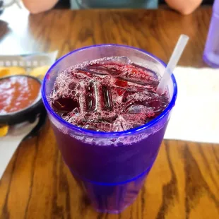 a purple drink in a plastic cup