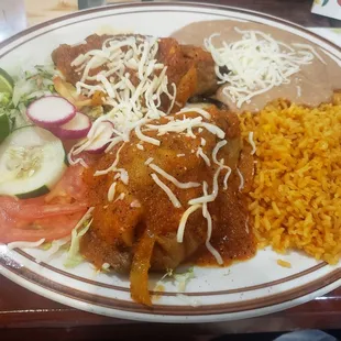 Chiles Rellenos - 2 Poblano Peppers stuffed with your choice of meat (Chicken), topped w/ Ranchera sauce, served w/ Rice, Beans, &amp; Salad.