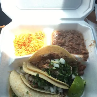 two tacos in a styrofoam container
