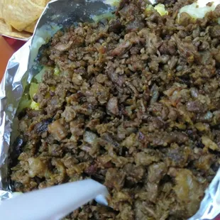 Loaded baked potato, not the real deal. They shape a piece of aluminum foil and toss pieces of potato in there with toppings. Sad.