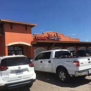 two trucks parked in front of a restaurant