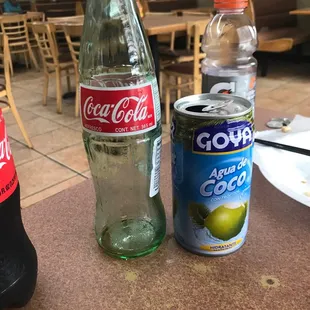 a bottle of coke and a can of soda