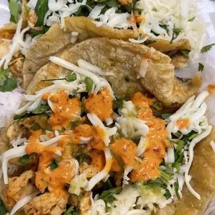 3 chicken tacos, no onion, add cheese.  The orange and red sauces will add some heat!