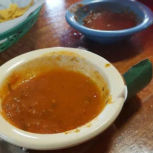 The lighter colored salsa is the spicier one.