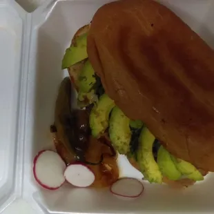 a sandwich in a styrofoam container