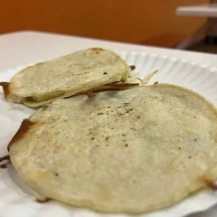 two tortillas on a paper plate