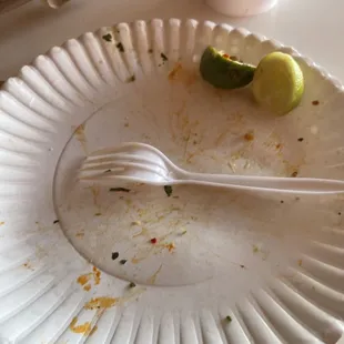 a white plate with a fork and limes on it
