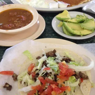 Carne Asada taco, avocado, frijoles borrachos, Carne Asada taco,  eggs, sausage, bacon, pancake, toast!