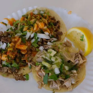 two tacos on a paper plate