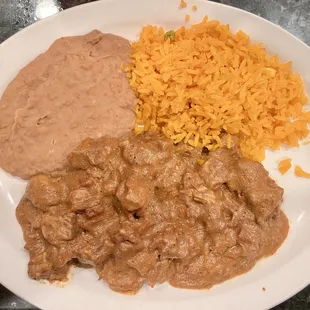 Carne guisada, rice, and beans.