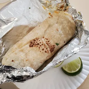 a burrito wrapped in aluminum foil
