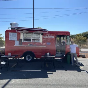 a man standing next to a food truck