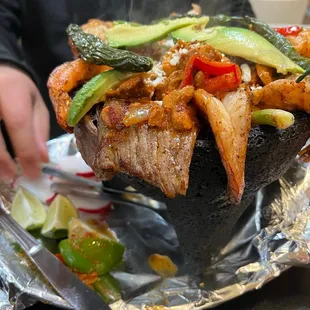 a person holding a piece of meat