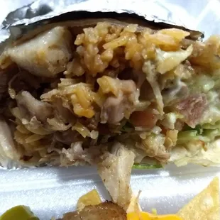 Carnitas supreme burrito - sour cream, quac sauce, rice , beans