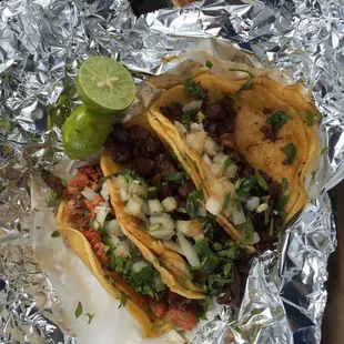 Two suadero and one longaniza. Both salsas had good flavor and spice but the green stood out.