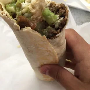 Carne asada burrito with guacamole and cheese. The carne asada flavor will have you slobbering.