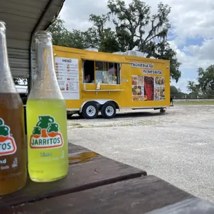 a yellow food truck parked in a parking lot