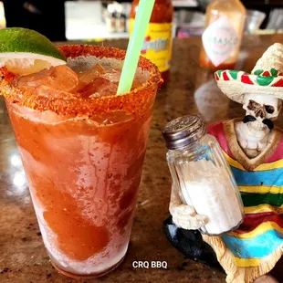 a mexican drink and a skeleton figurine