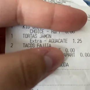 a hand holding a receipt