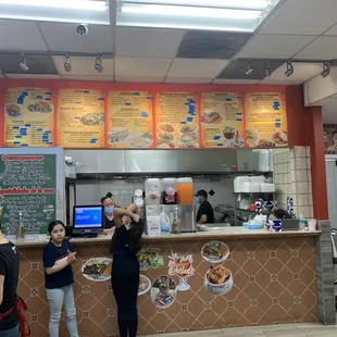 a group of people standing in front of a counter