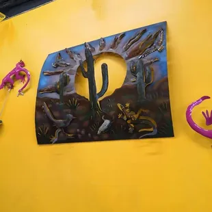 a desert scene on a yellow wall