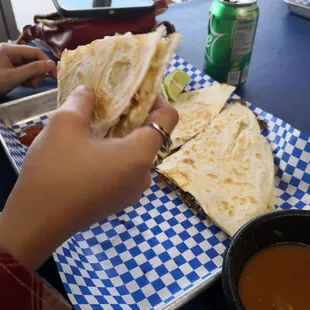 a person eating a quesadilla