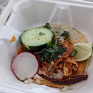 a close up of a taco in a styrofoam container