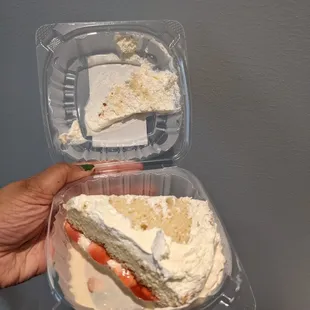 a person holding a piece of cake