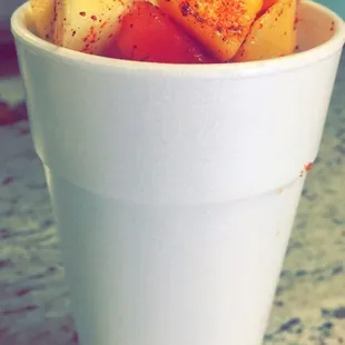 a white cup filled with fruit