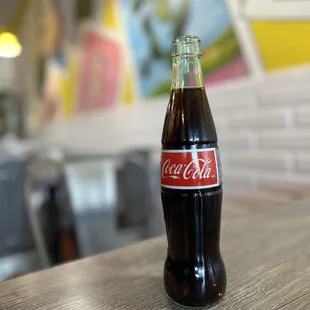 a coca cola bottle on a table