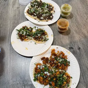 three plates of tacos on a table