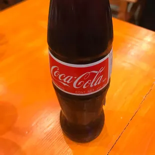 a bottle of coca cola on a table