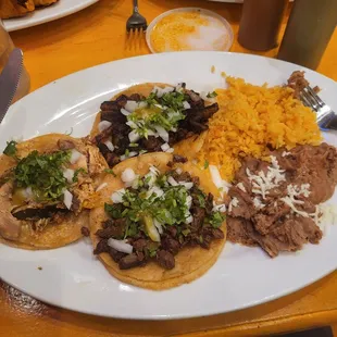 3 taco dinner with carne asada, chicken, and al pastor tacos.