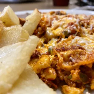 Chorizo, eggs and cheese with a side of refried beans and potatoes