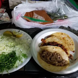 Adobada, buche, and desebrada tacos with salsa, chiles, onions, cilantro, and Cabbage