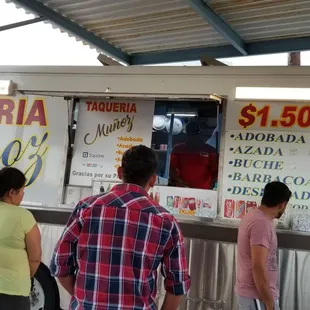 a group of people standing in front of a food truck